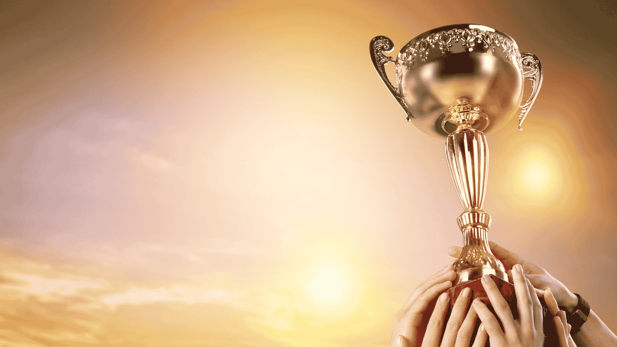 people holding a trophy over head