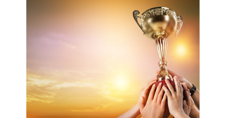 people holding a trophy over head