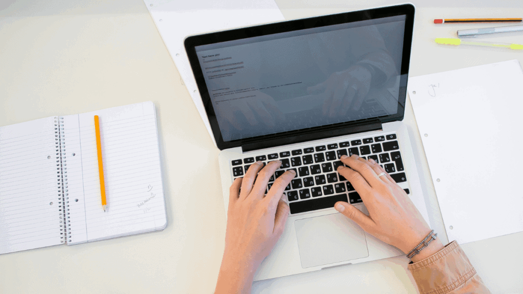 working on laptop with documents