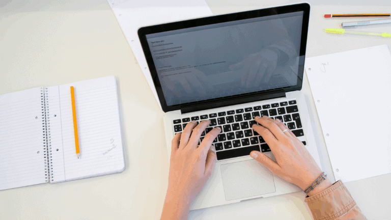 working on laptop with documents