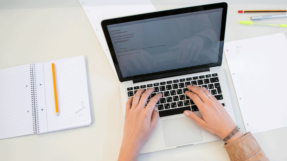 working on laptop with documents