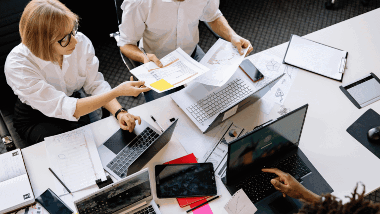 Employees Having a Meeting while Sitting in front of their Laptops