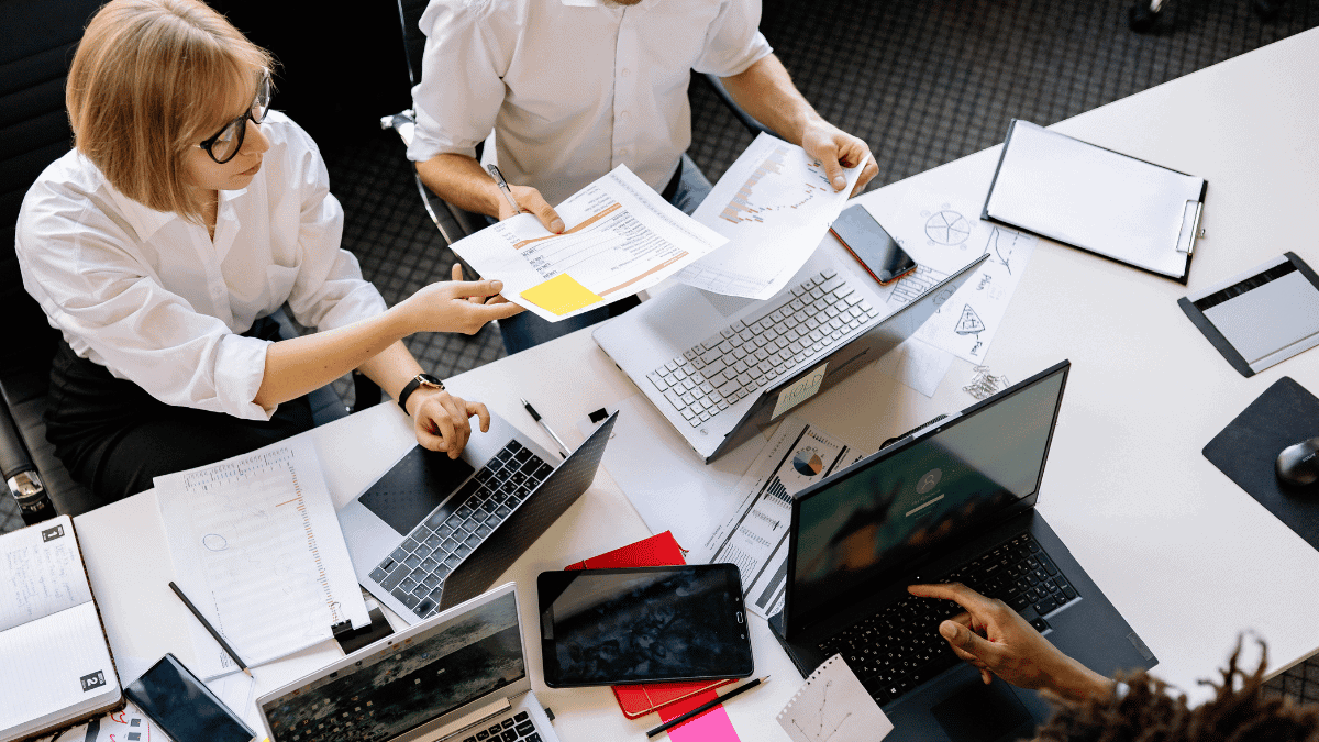 Employees Having a Meeting while Sitting in front of their Laptops