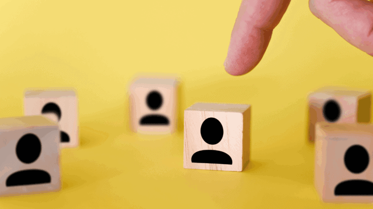 The search for new managers to lead organizations and teams is shown using wooden cubes, on a yellow background.