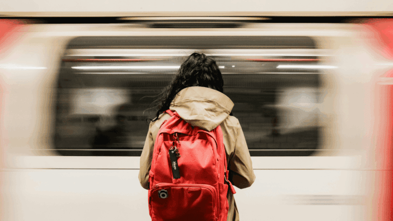 Commuter with Red Backpack at London Underground Station