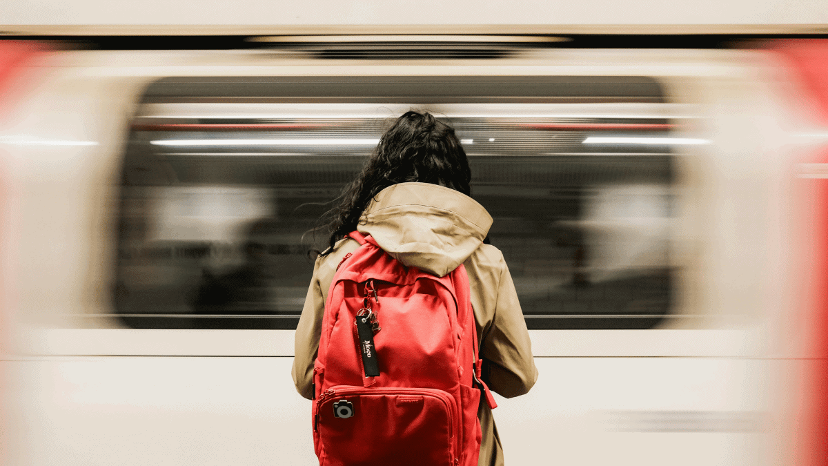 Commuter with Red Backpack at London Underground Station