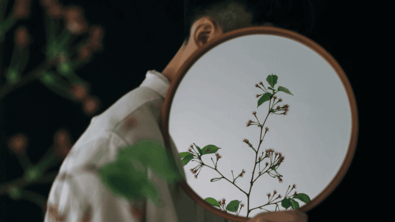 Man with Flowers Reflecting in Mirror