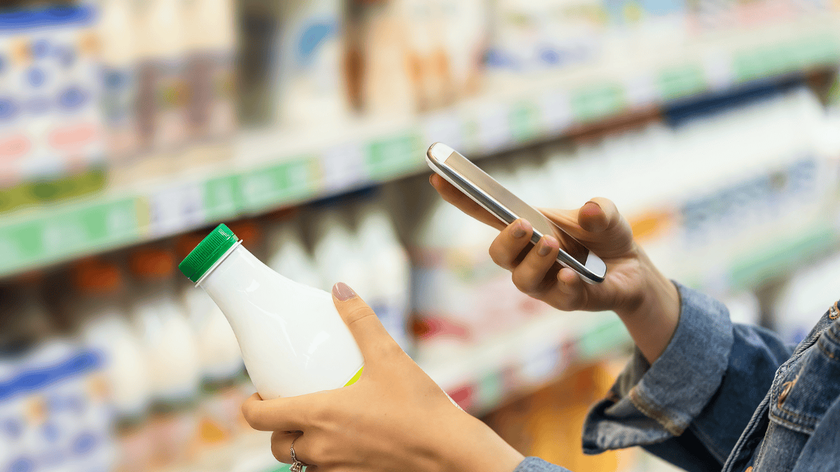 person using phone in a shop