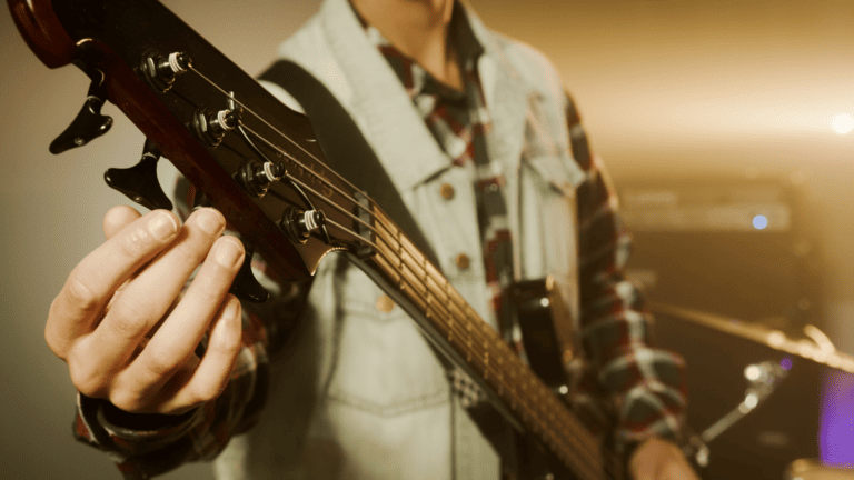 a stage performer tuning an electric guitar