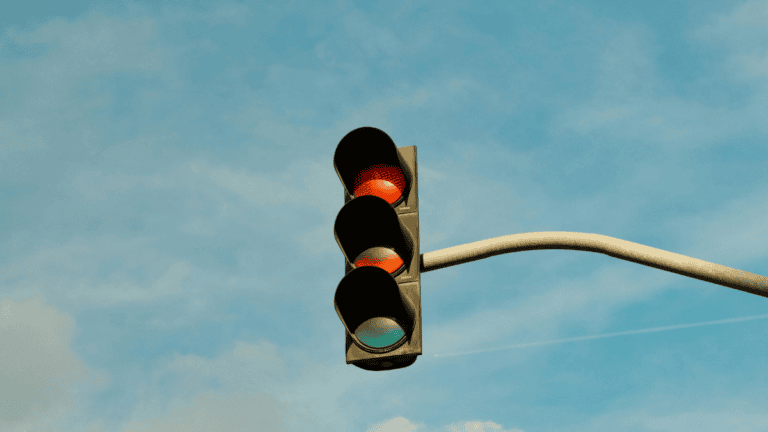 a traffic light on a background of blue sky